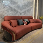 Curved Terracotta Leather Sofa and Blue Accent Chair Set with High-Gloss Wood Details